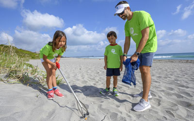 A family of volunteers help clean the beach near Loggerhead Marinelife Center in Juno Beach as part of FPL’s Power to Care Day. Employees and their families volunteer to give back to their communities. 