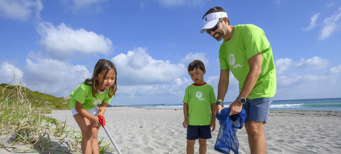 A family of volunteers help clean the beach near Loggerhead Marinelife Center in Juno Beach as part of FPL’s Power to Care Day. Employees and their families volunteer to give back to their communities. 