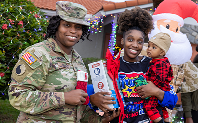 Terella Brown, left, is an Army soldier for the Florida National Guard who was surprised with a holiday home makeover thanks to FPL. 